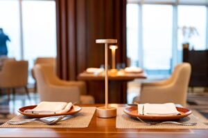 Two cordless table lamps lit on adjacent restaurant tables